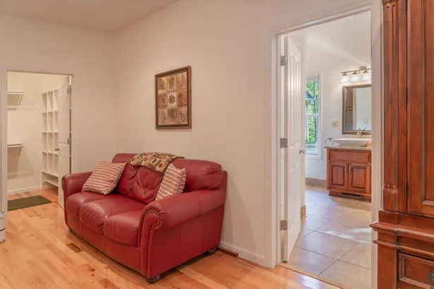 a bathroom with a tub sink and mirror