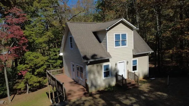 a view of a house with backyard and sitting area
