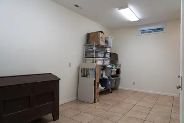 a view of a room with wooden floor and entryway