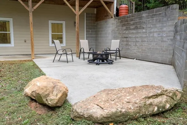 a backyard of a house with table and chairs