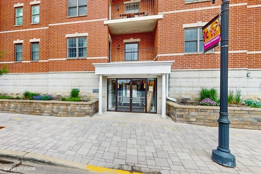 210 North Addison Avenue, Unit 202 Elmhurst, IL 60126 - Photo 1 of 21 a front view of a building with garden