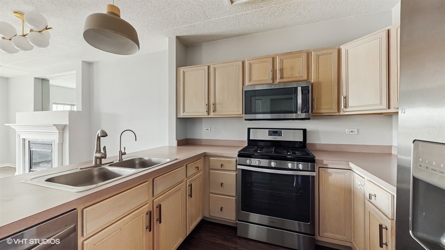 210 North Addison Avenue, Unit 202 Elmhurst, IL 60126 - Photo 8 of 21 a kitchen with cabinets appliances a sink and a counter top space