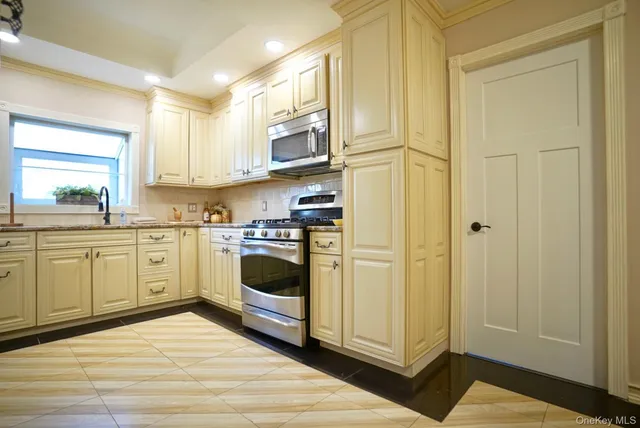 a kitchen with a refrigerator sink and cabinets