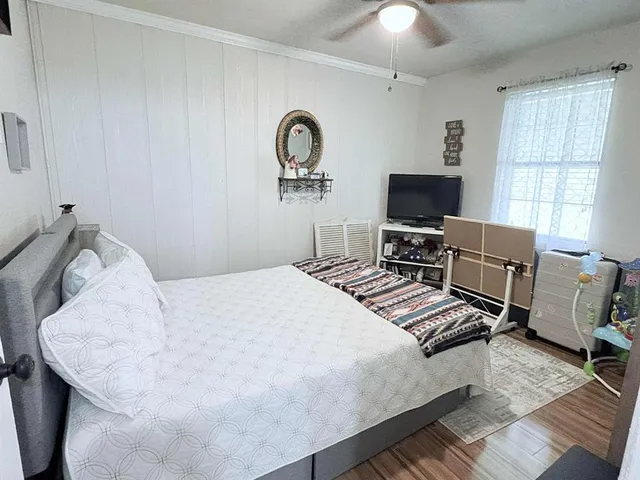 a bedroom with a bed and a flat screen tv