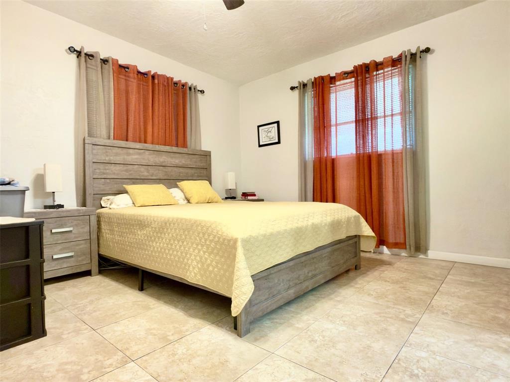 4510 Northwest 46th Street Tamarac, FL 33319 - Photo 15 of 34 a bedroom with a bed and a dresser