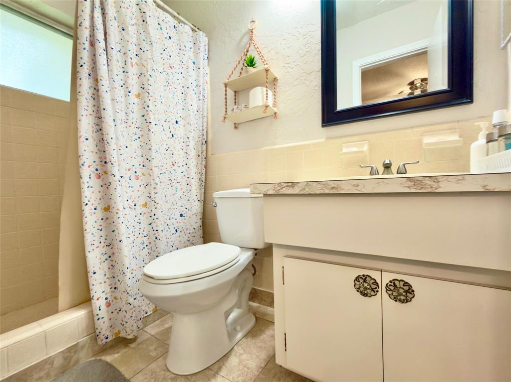 4510 Northwest 46th Street Tamarac, FL 33319 - Photo 16 of 34 a bathroom with a toilet sink and mirror