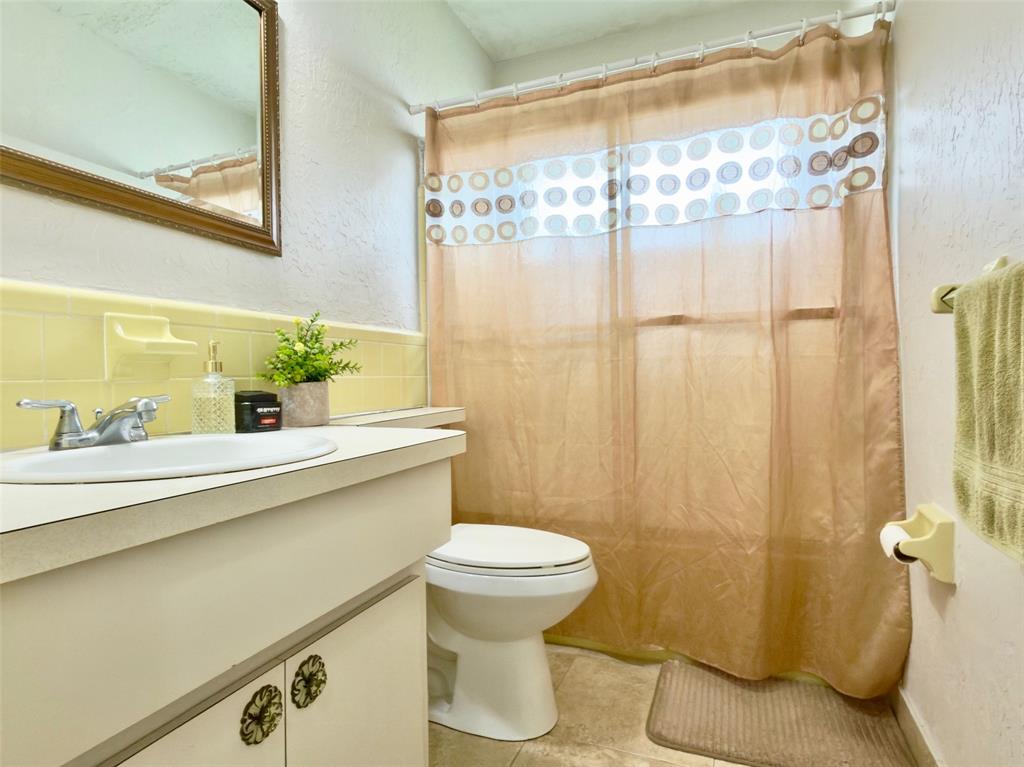 4510 Northwest 46th Street Tamarac, FL 33319 - Photo 22 of 34 a bathroom with a sink and a mirror