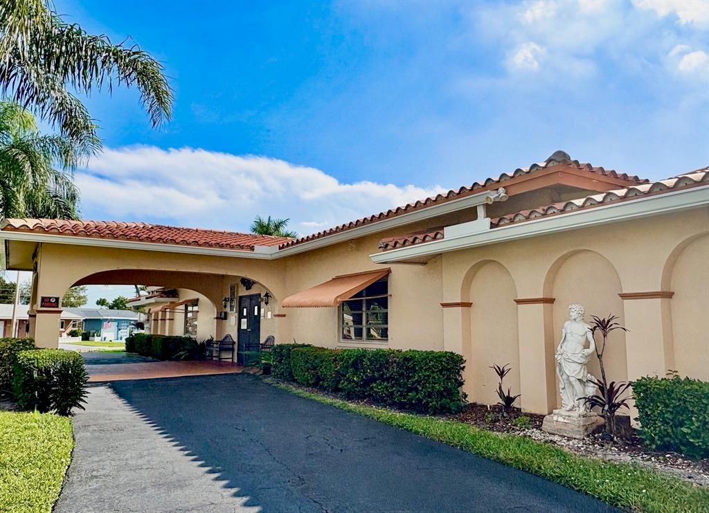 4510 Northwest 46th Street Tamarac, FL 33319 - Photo 25 of 34 a front view of a house with garden