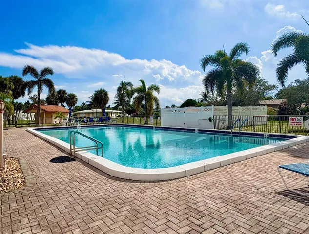 a view of a backyard with swimming pool