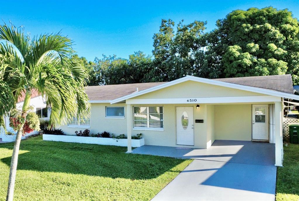 4510 Northwest 46th Street Tamarac, FL 33319 - Photo 31 of 34 a view of a house with a yard