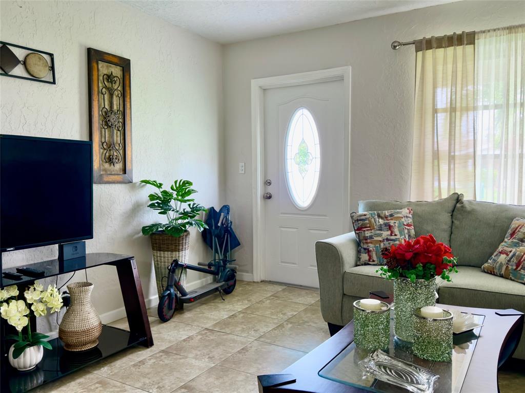 4510 Northwest 46th Street Tamarac, FL 33319 - Photo 6 of 34 a living room with furniture and a potted plant