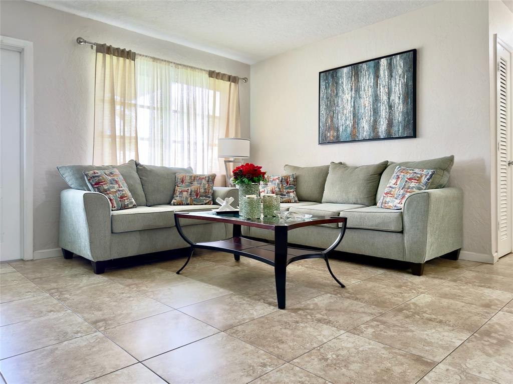 4510 Northwest 46th Street Tamarac, FL 33319 - Photo 7 of 34 a living room with furniture and a large window