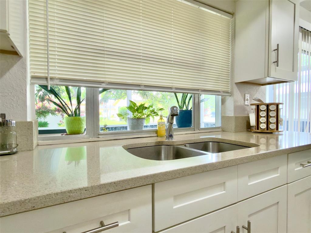4510 Northwest 46th Street Tamarac, FL 33319 - Photo 10 of 34 a view of a kitchen counter top a sink and wooden floor