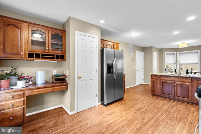 a kitchen with stainless steel appliances granite countertop a refrigerator and a sink