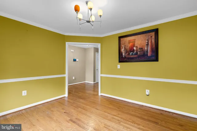 a view of a room with wooden floor and cabinet