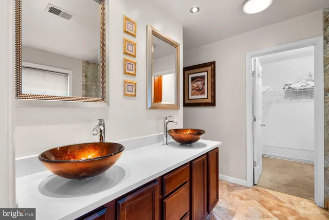 a view of a bathroom with a sink and a mirror