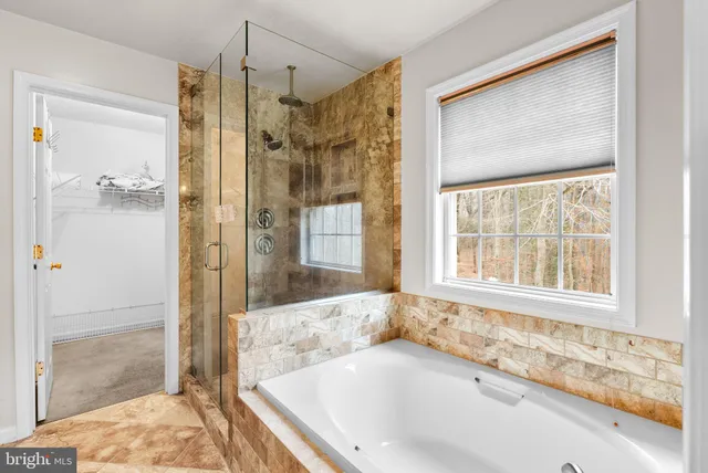 a bathroom with a tub and a shower