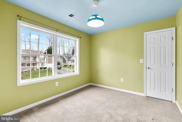 an empty room with windows and entrance