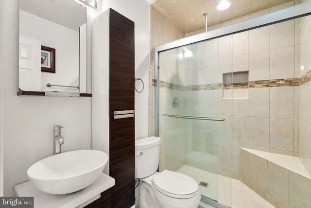 a bathroom with a toilet sink and shower