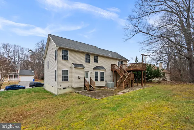 a view of a house with a yard patio and fire pit
