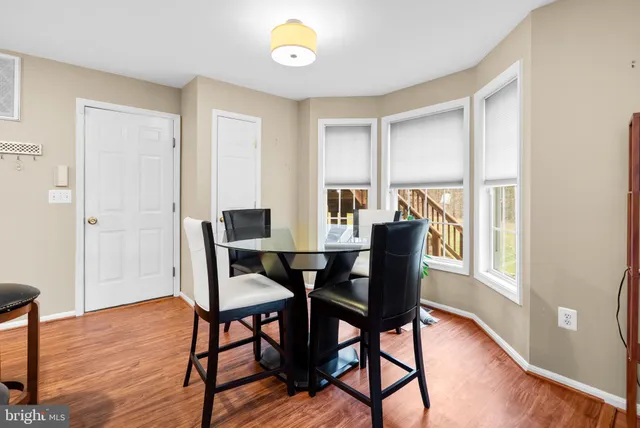 a dining room with furniture and wooden floor