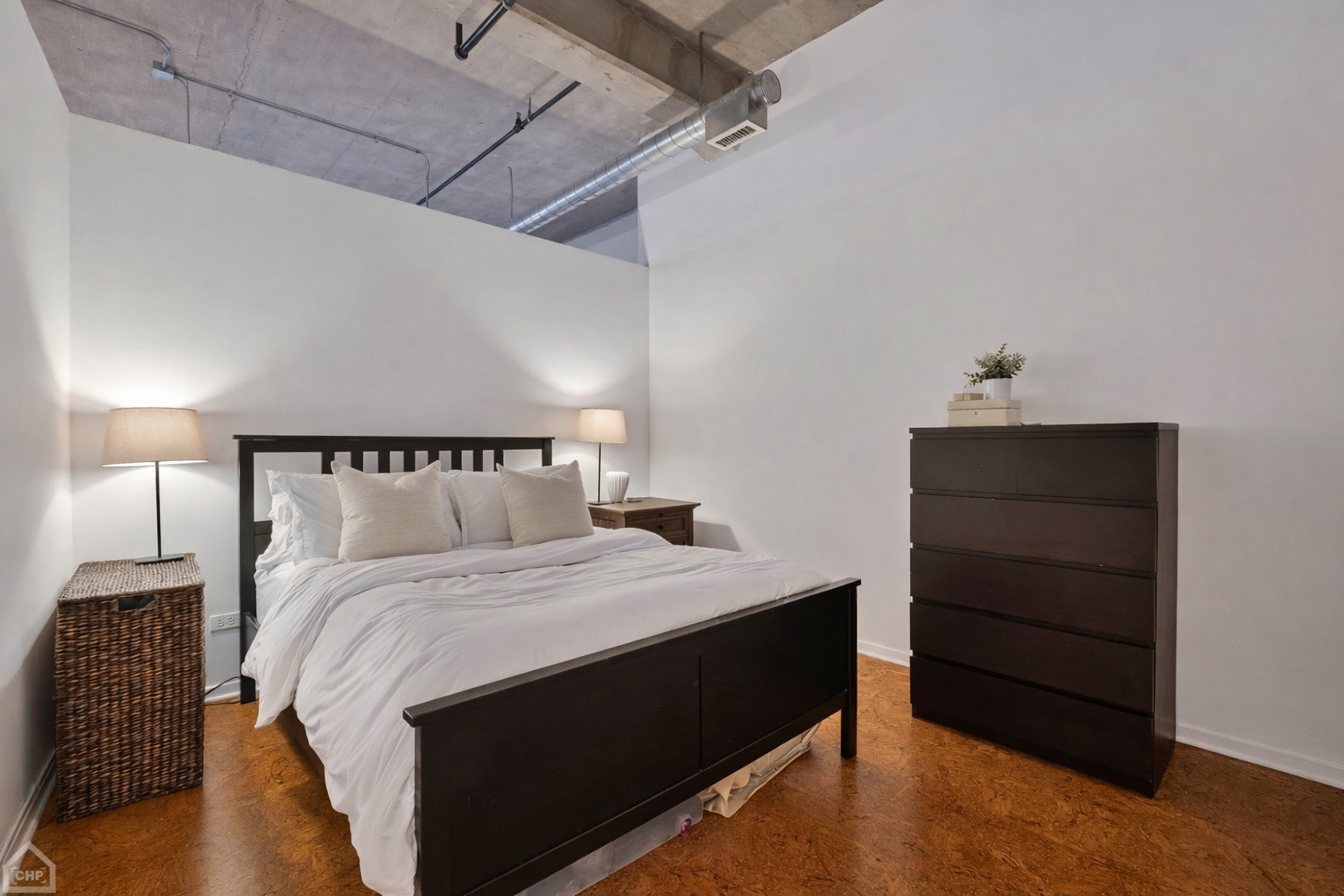 210 South Desplaines Street, Unit 404 Chicago, IL 60661 - Photo 11 of 22 a bedroom with a bed and a dresser