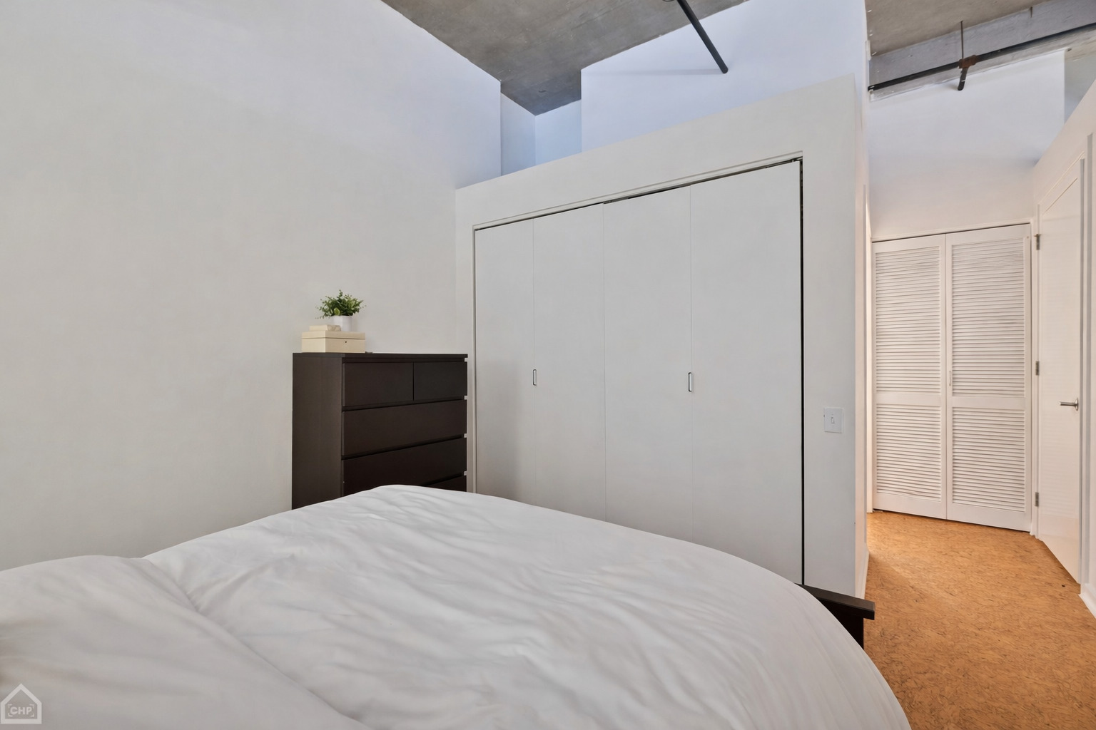 210 South Desplaines Street, Unit 404 Chicago, IL 60661 - Photo 12 of 22 a bedroom with a bed and a dresser