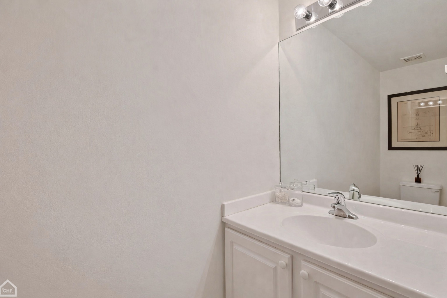 210 South Desplaines Street, Unit 404 Chicago, IL 60661 - Photo 14 of 22 a bathroom with a sink and a mirror