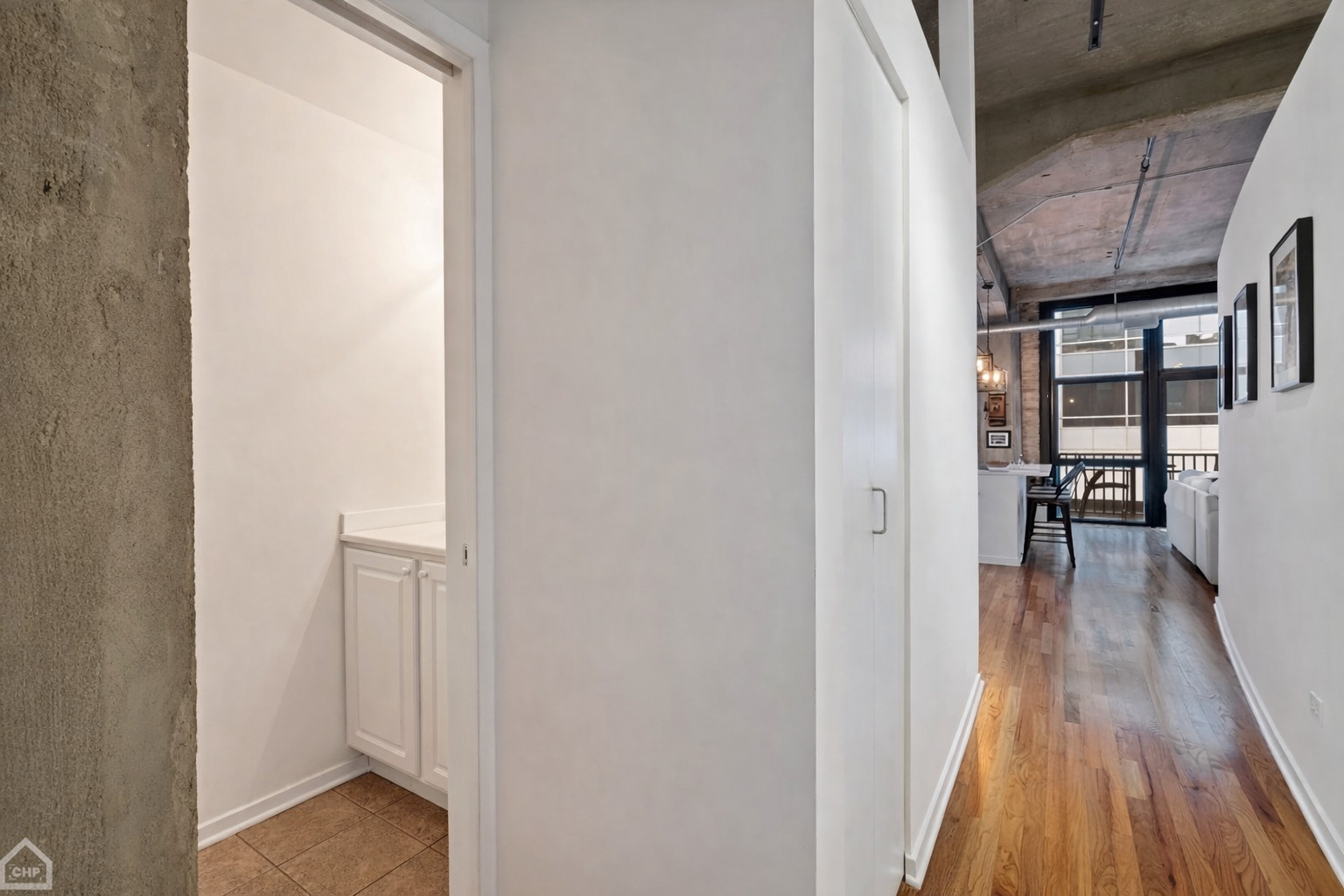 210 South Desplaines Street, Unit 404 Chicago, IL 60661 - Photo 16 of 22 a view of a hallway with wooden floor and dining room