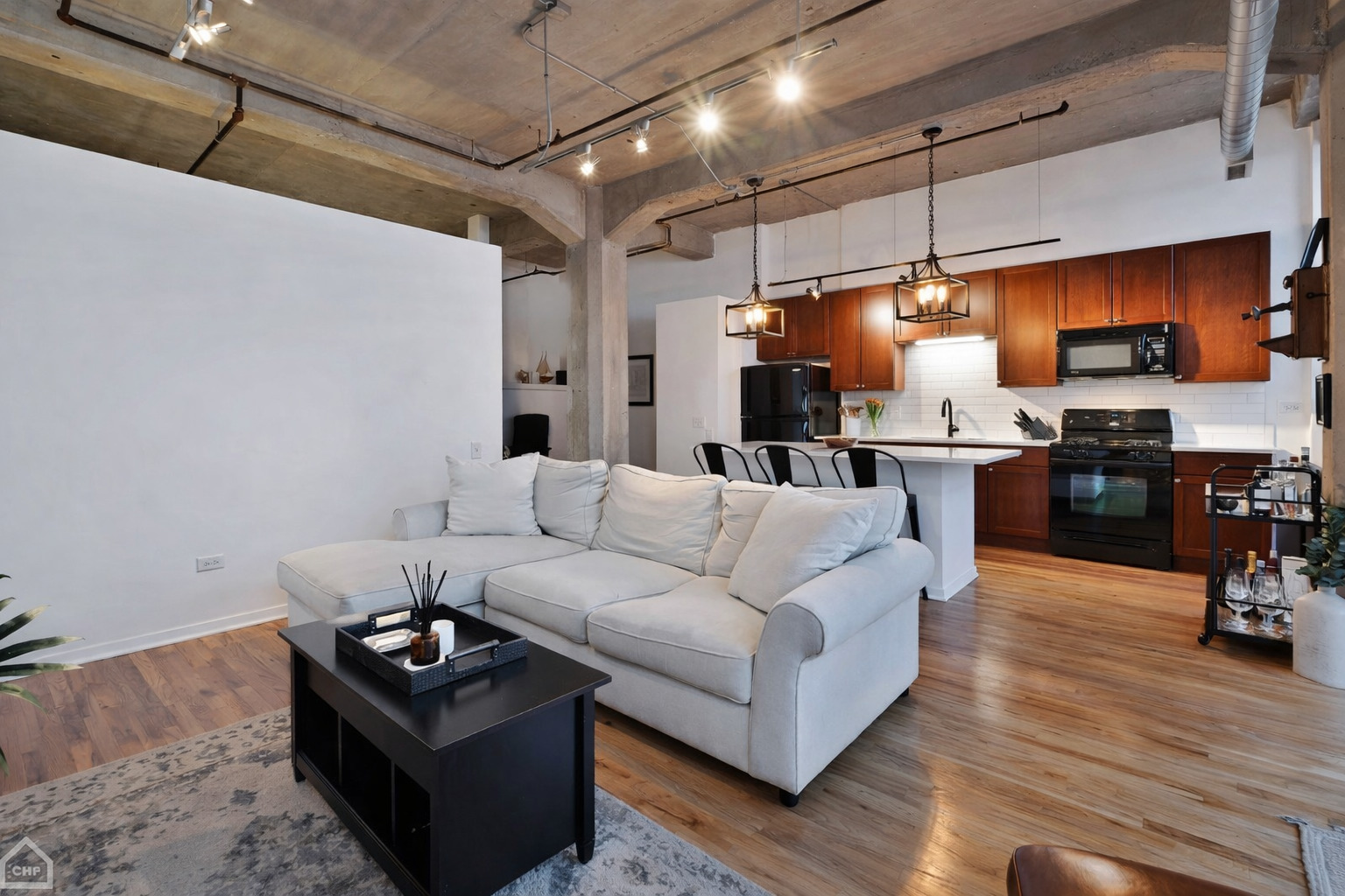 210 South Desplaines Street, Unit 404 Chicago, IL 60661 - Photo 8 of 22 a living room with furniture kitchen view and a wooden floor