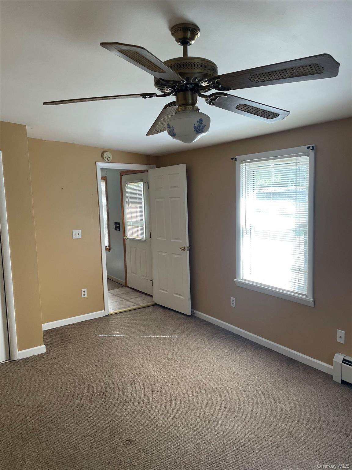 67 Bethlehem Road New Windsor, NY 12553 - Photo 8 of 19 Unfurnished bedroom with carpet floors, baseboard heating, and ceiling fan