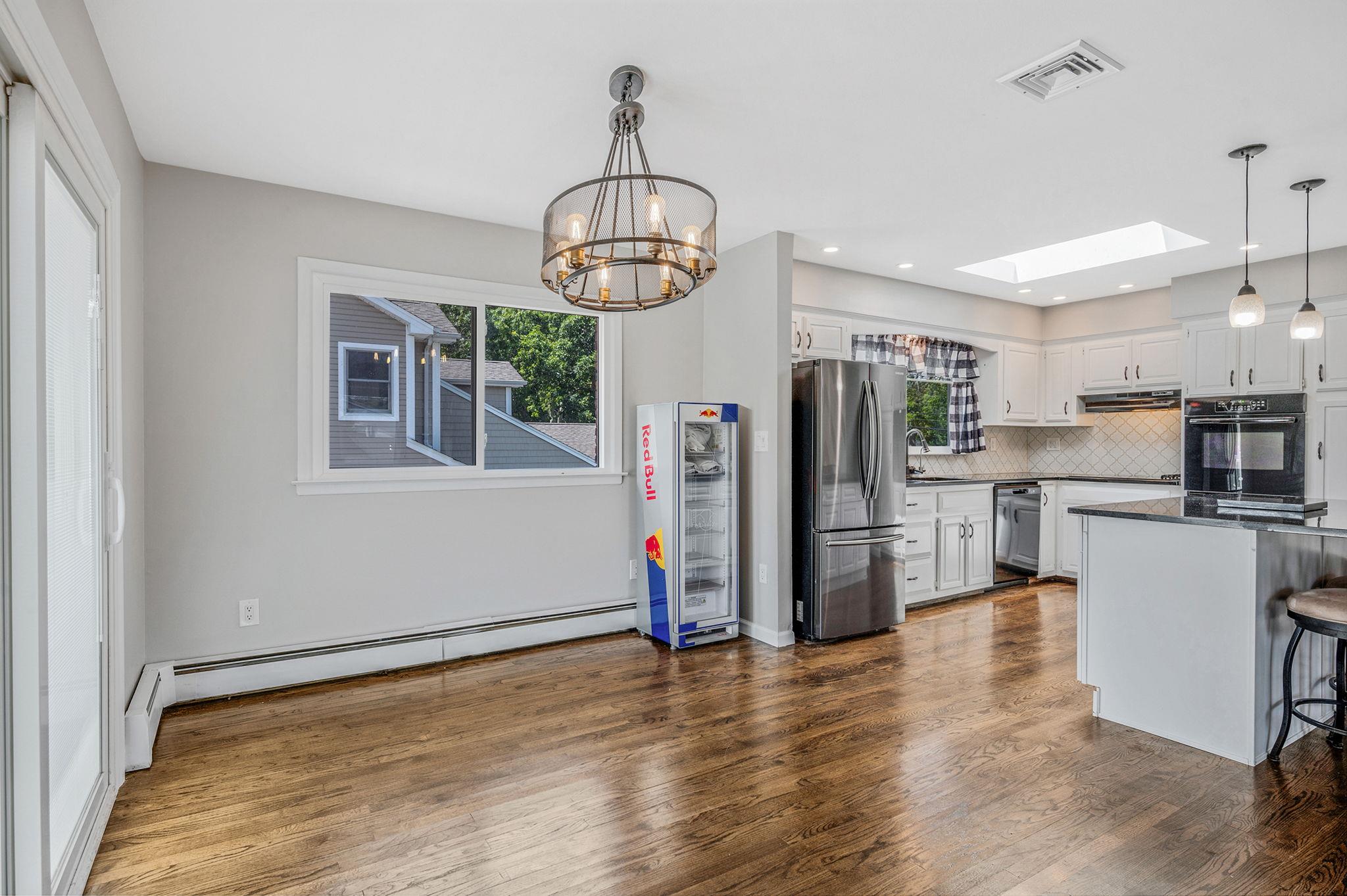 6 Holly Road Oakdale, NY 11769 - Photo 15 of 34 a kitchen with stainless steel appliances a refrigerator a stove microwave and white cabinets