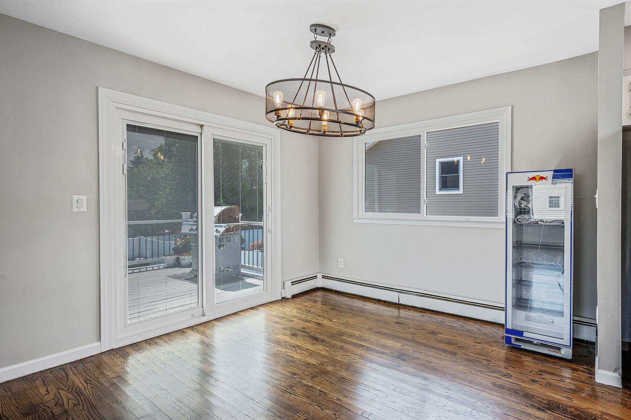 6 Holly Road Oakdale, NY 11769 - Photo 16 of 34 an empty room with wooden floor a glass door and windows