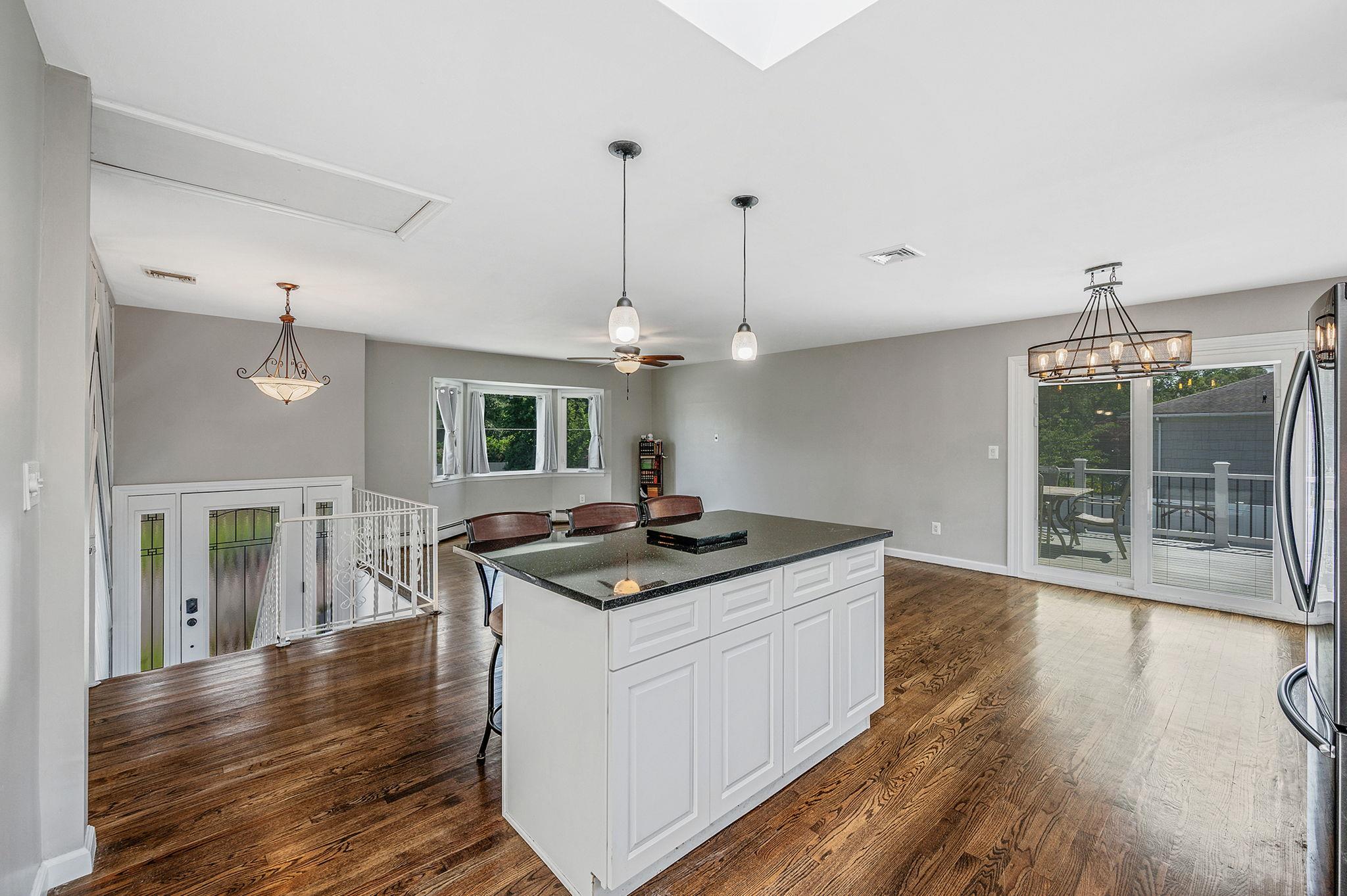 6 Holly Road Oakdale, NY 11769 - Photo 21 of 34 a kitchen with stainless steel appliances granite countertop a sink stove and wooden floor