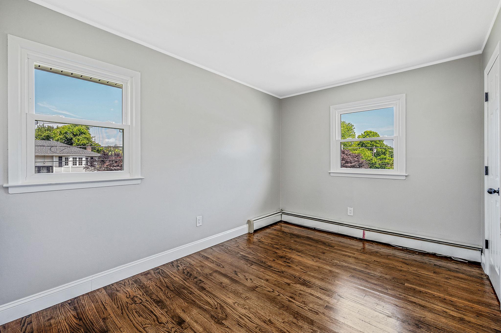 6 Holly Road Oakdale, NY 11769 - Photo 24 of 34 a view of empty room with wooden floor and fan