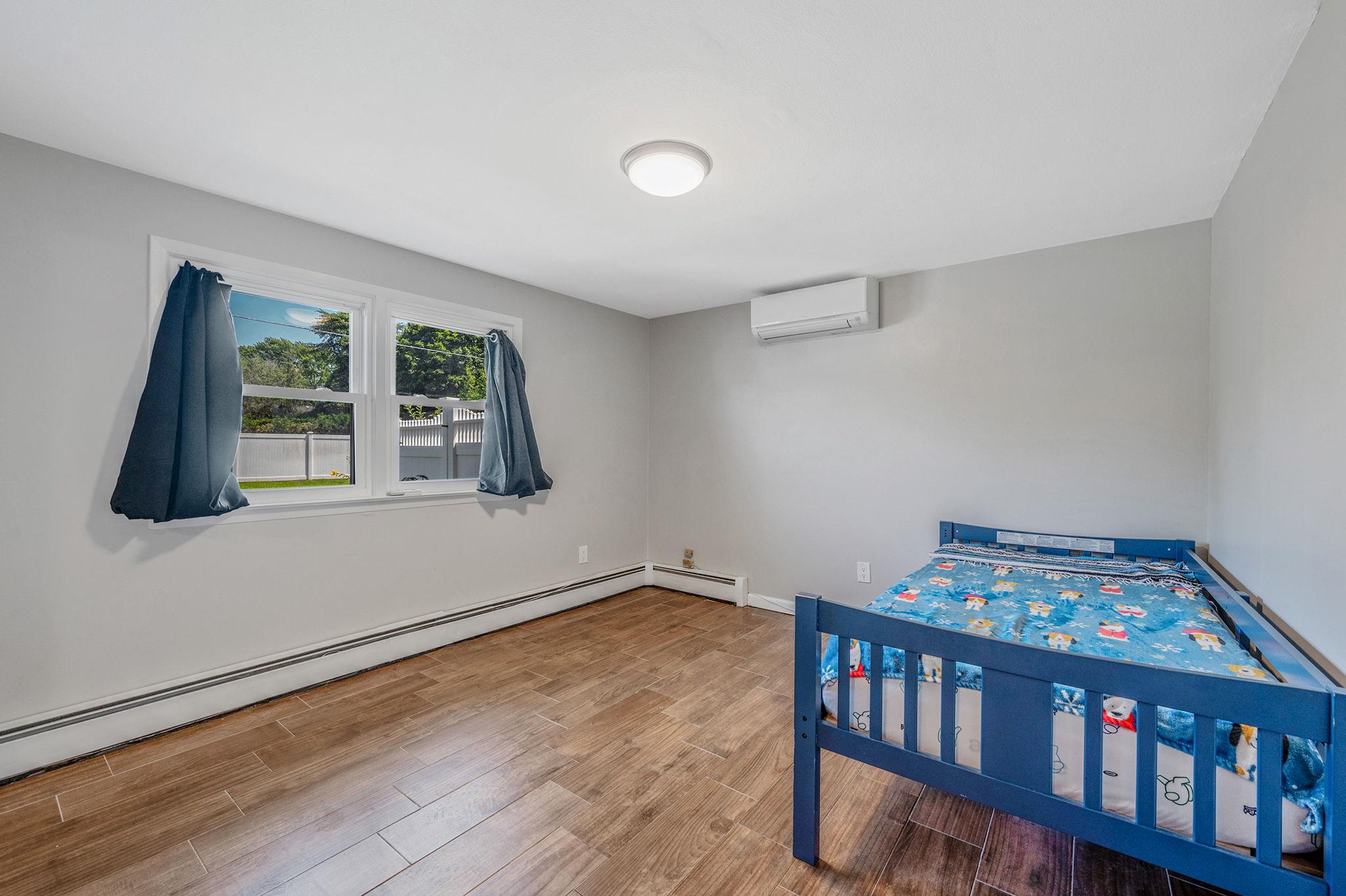 6 Holly Road Oakdale, NY 11769 - Photo 29 of 34 a bedroom with furniture and a book shelf