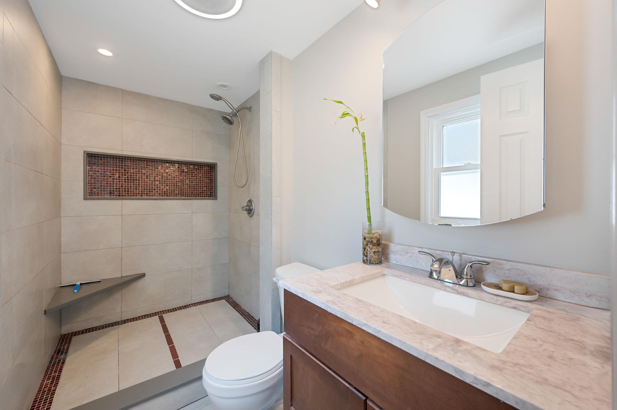 6 Holly Road Oakdale, NY 11769 - Photo 33 of 34 a bathroom with a granite countertop sink mirror vanity and toilet