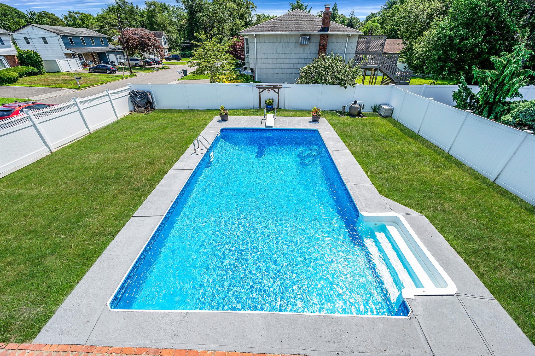 6 Holly Road Oakdale, NY 11769 - Photo 6 of 34 a view of swimming pool with a backyard