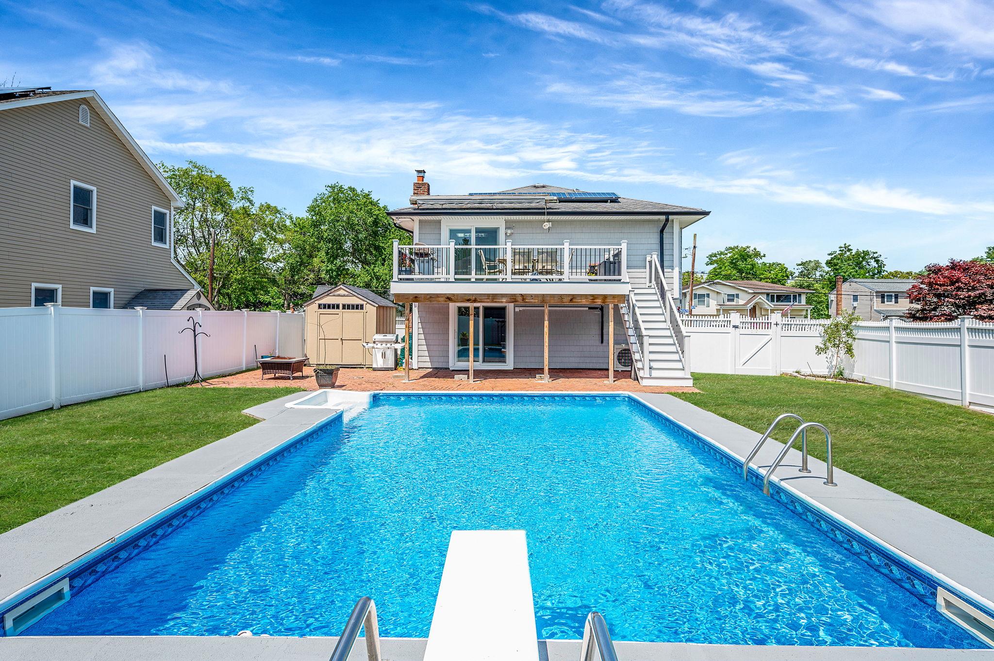 6 Holly Road Oakdale, NY 11769 - Photo 8 of 34 a view of an house with swimming pool and a yard