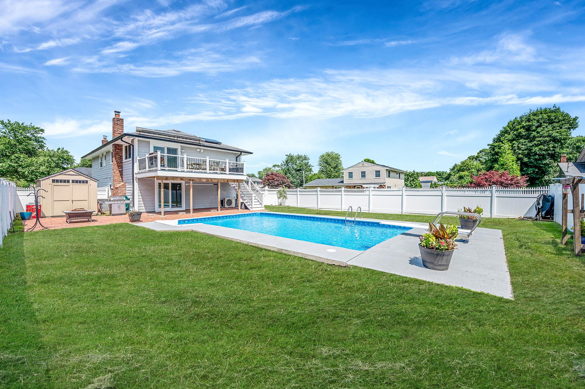 6 Holly Road Oakdale, NY 11769 - Photo 9 of 34 a view of a house with a backyard porch and sitting area