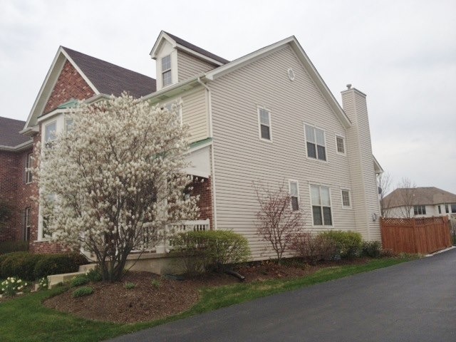 1907 Wagner Road, Unit 1907 Batavia, IL 60510 - Photo 22 of 22 a front view of a house with a yard and garage