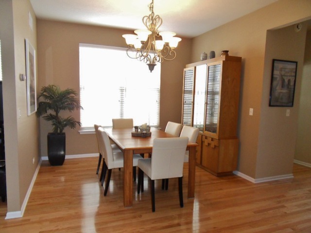 1907 Wagner Road, Unit 1907 Batavia, IL 60510 - Photo 8 of 22 a view of a dining room with furniture window and wooden floor