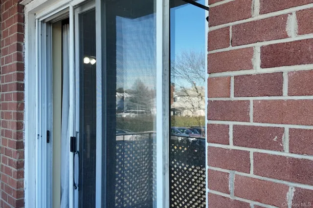 a view of backyard with wooden fence and large trees