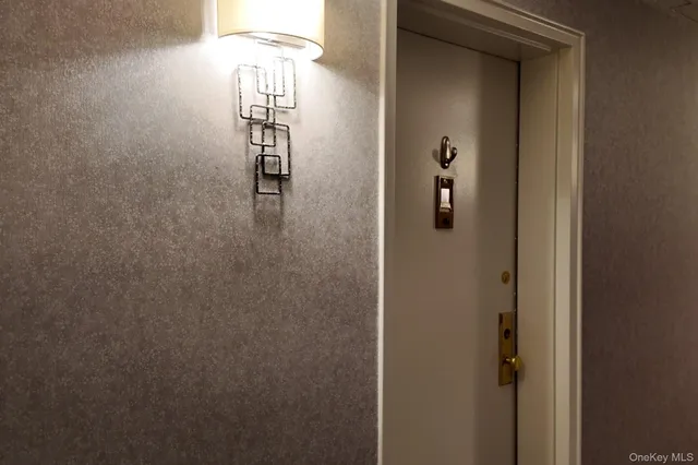 a hallway with wooden floor and stairs