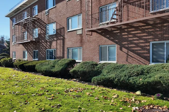 a view of a street with a building and a street sign