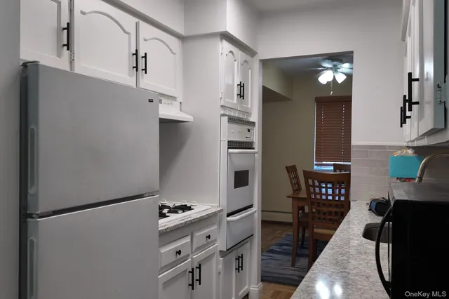 a kitchen with stainless steel appliances a refrigerator and a stove top oven
