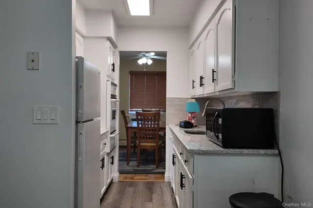 a kitchen with stainless steel appliances a stove a refrigerator a sink and cabinets