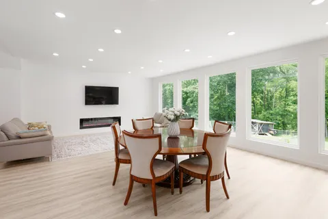 a kitchen with stainless steel appliances a sink a large window and wooden floor
