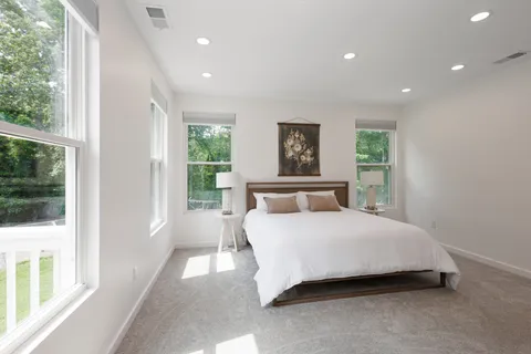 a bedroom with a bed and a book shelf