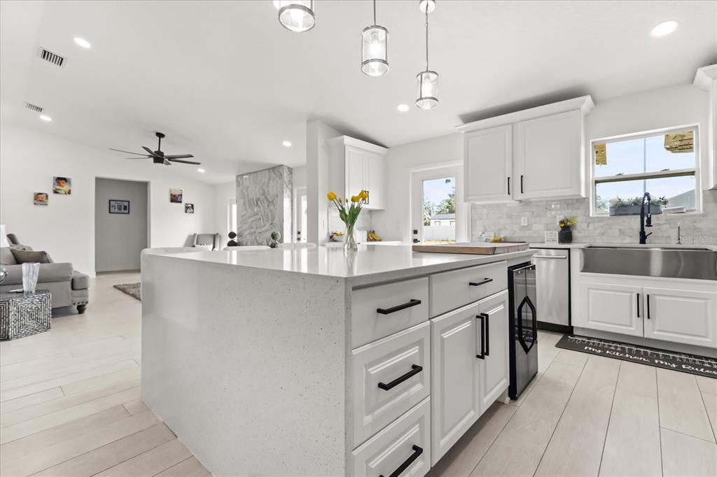 812 Chastain Road Seffner, FL 33584 - Photo 4 of 26 a kitchen with kitchen island granite countertop a sink cabinets and stainless steel appliances